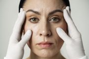 front-view-hands-with-gloves-touching-woman-s-face